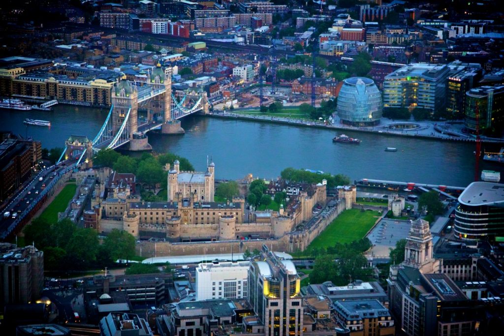 Lightshow and lowering of the rings on Tower bridge. Aerial shot at night.